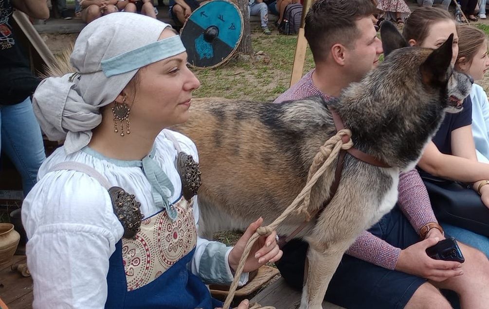 Young lady in medieval clothing with her dog.