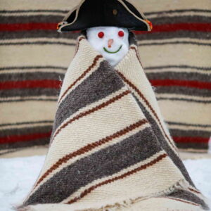 A snowman wrapped in a hand-woven blanket